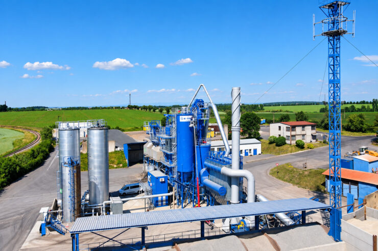 letecký pohled na průmyslový areál s modrými sily a dopravníkem