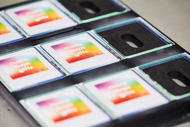 UV printing of a color logo on a set of items held in a jig