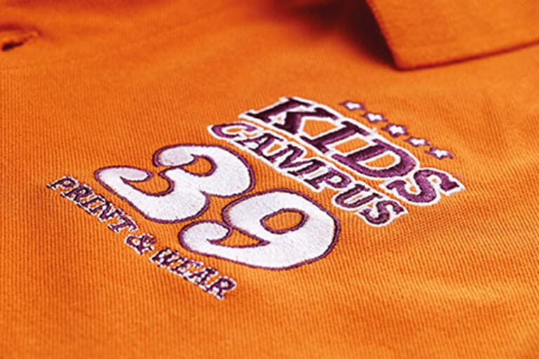 detail of Kids Campus embroidery on an orange sweatshirt